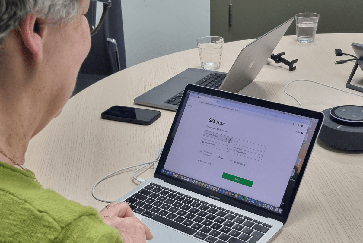 Person working on a laptop with a login screen visible on the display.